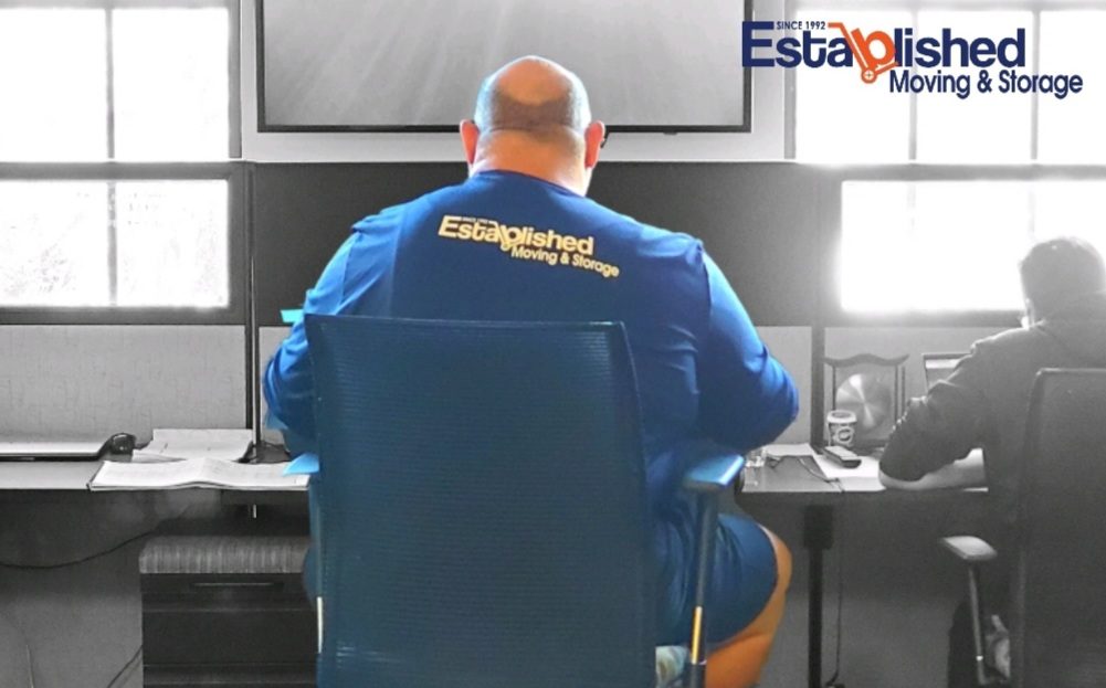 an employee of established moving & storage sits at a desk