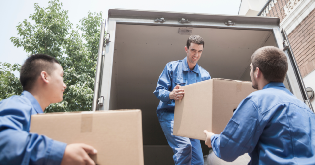 A team of movers loading boxes into a moving truck